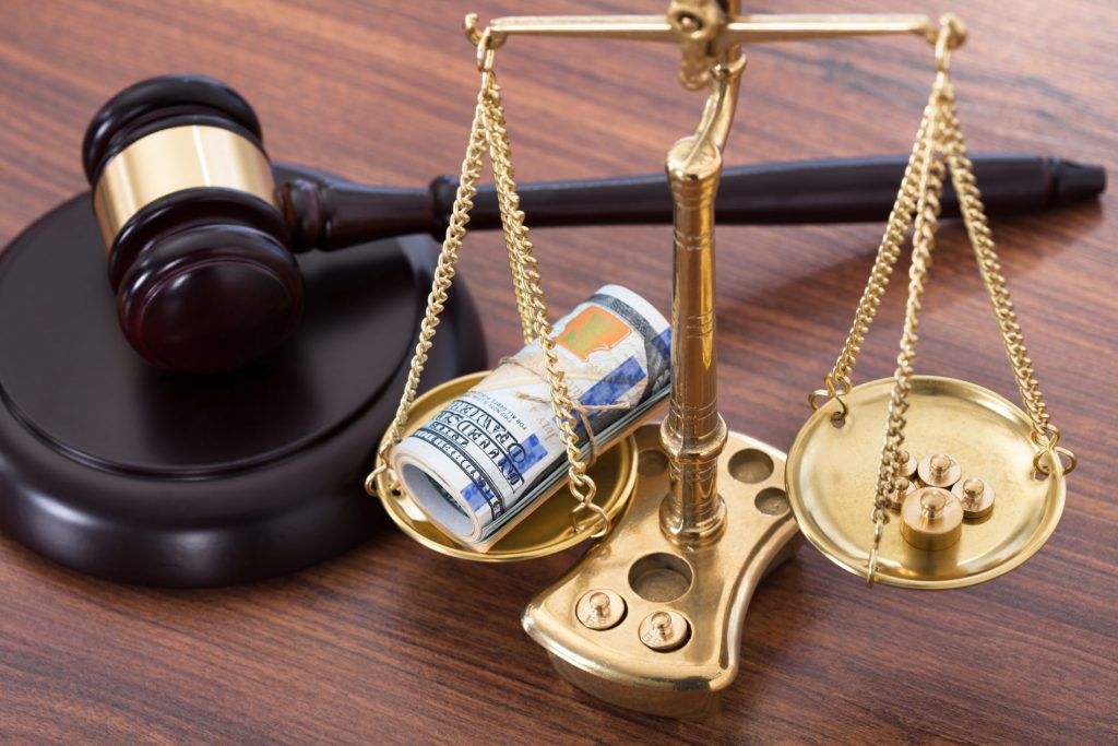 Gavel And Scales With Money On Desk